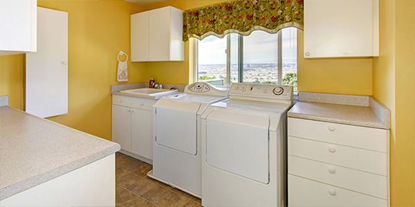 Old White Cabinets in Yellow Laundry Room