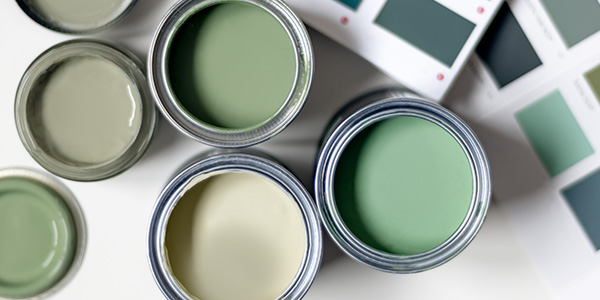 Open Cans of Green Paint in Different Shades and Green Paint Color Swatches