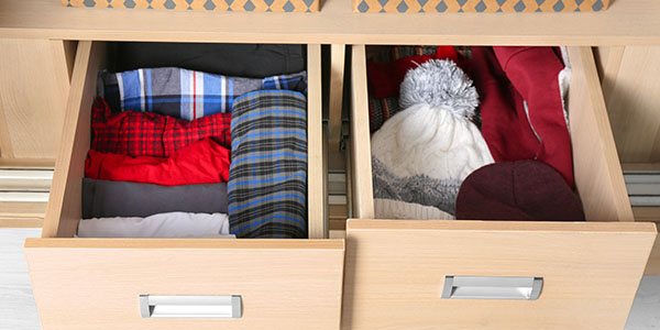Open Drawer Full of Organized Winter Clothes