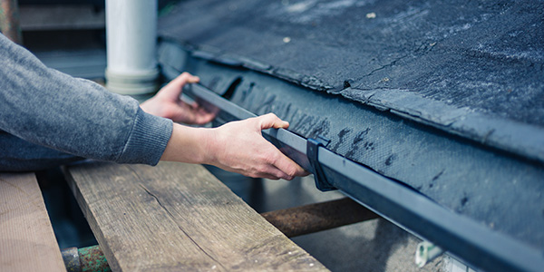 Person Repairing a Gutter