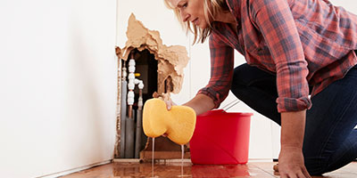 Woman Mopping Up Home Water Damage