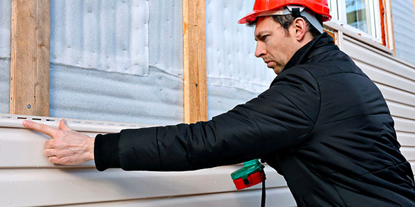 Man Holding Vinyl Siding Nail Strip