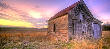 Old Barn in a Field at Sunrise