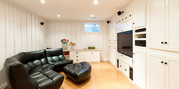 White Basement With Large Black Sectional