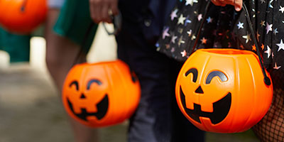 Kids Holding Pumpkin Trick or Treat Baskets on Halloween