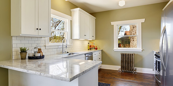 Freshly Updated Small Kitchen With White Cabinets and Subway Tile