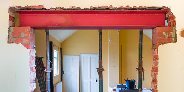 Hole in Garage Wall With Exposed Bricks and Beam