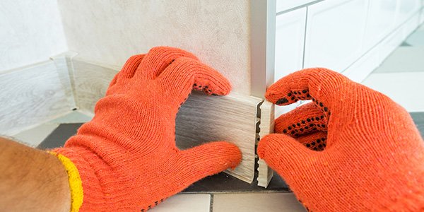 Baseboard Being Removed From a Wall