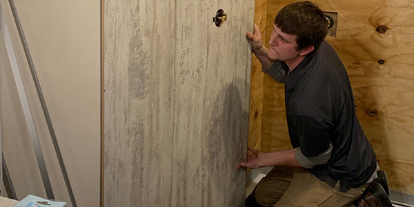 Male Contractor Replacing Shower Walls