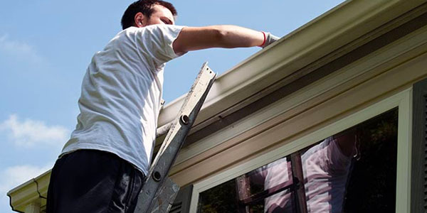 Man Cleaning Out Gutters