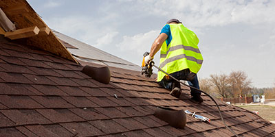 Person Inspecting Roof for Damage