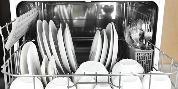 Dishwasher Filled With Plates, Bowls and Silverware