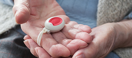 Senior Holding Medical Alert Button