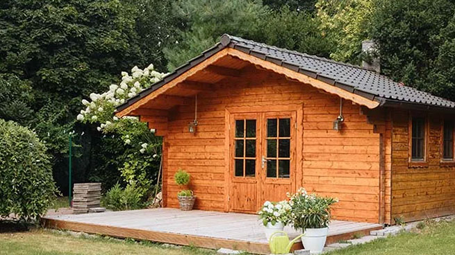 Wood Shed Surrounded by Green Grass and Trees