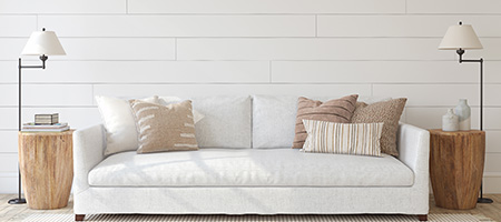 White Shiplap Wall With White Couch and Two End Tables