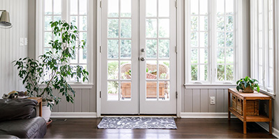 White Windows and Doors on Gray Beadboard Walls in Sunroom