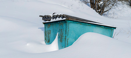 Dumpster Covered in Snow