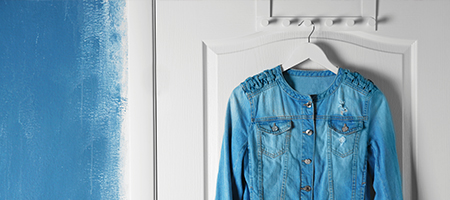 Jean Jacket Hanging on White Wall