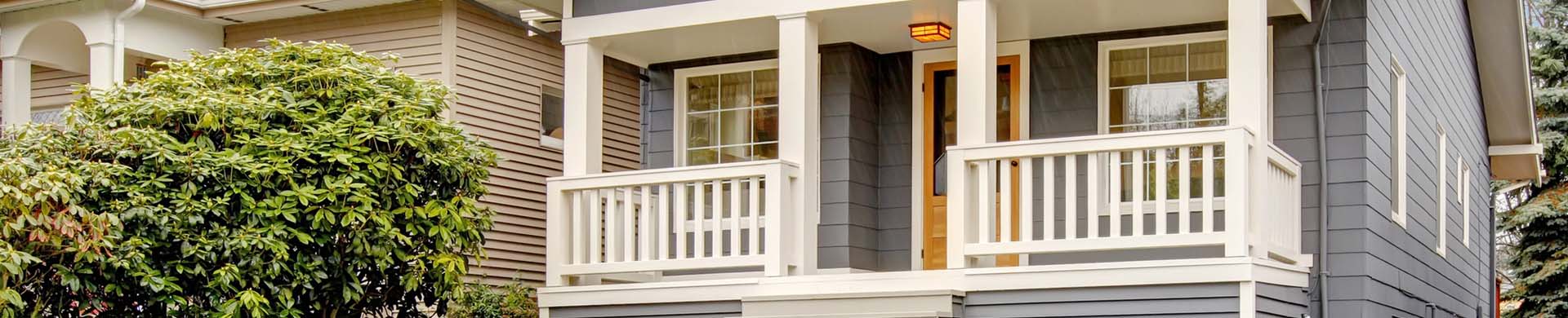 Grey House With Porch and Small Yard