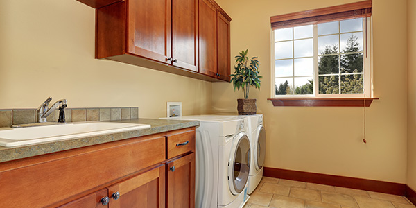 Clean Laundry Room With Washer, Dryer and Sink