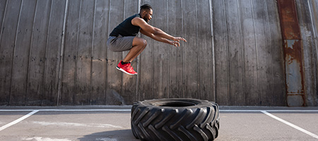 Man Jumping Over a Tire