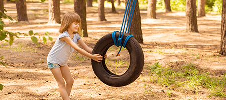 Girl Pushing a Tire Swing