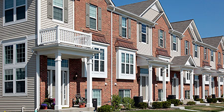 Traditional Townhouse in a Row of Attached Homes With Uniform Facades, and a Compact Design.