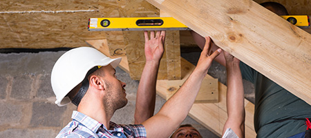 Group of People Checking Level of Basement Staircase