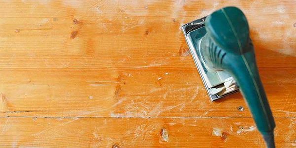 Power Sanding Tool on Golden Hardwood Floor