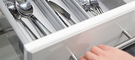 Kitchen Utensil Drawer Being Unpacked After Moving House