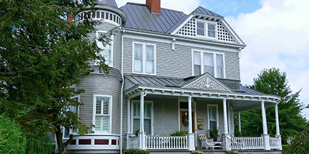 Gray Victorian Style Home: Ornate, Historical Elegance.