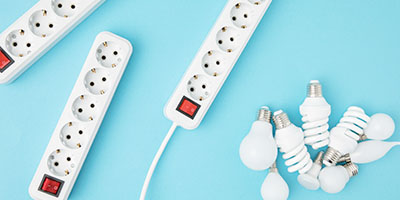 Extension Cords and Lightbulbs on Blue Background