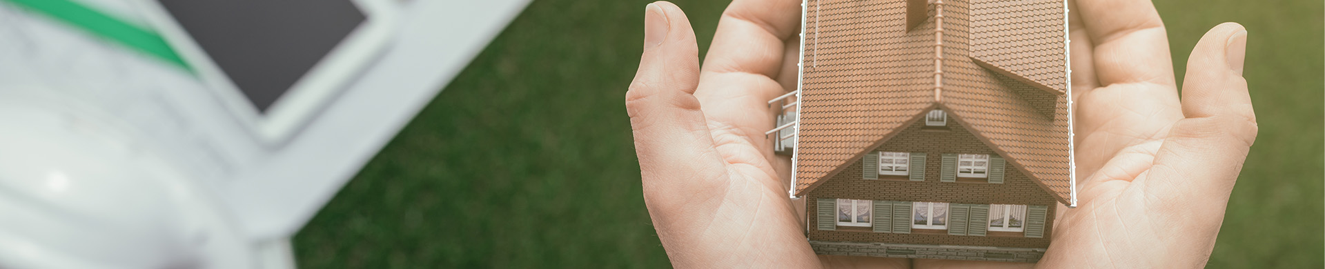 Small Brown House Held in Two Hands