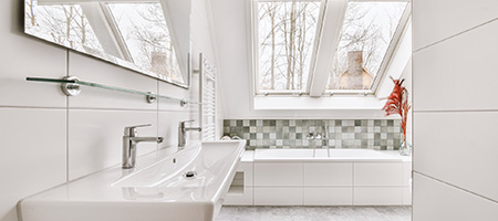 White Tiled Bathroom With a Wall of Small Gray Tiles