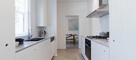 Galley Kitchen With White Walls
