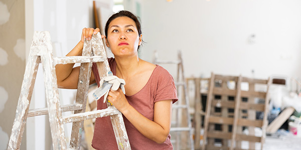 Woman Leaning Against Ladder During Renovation