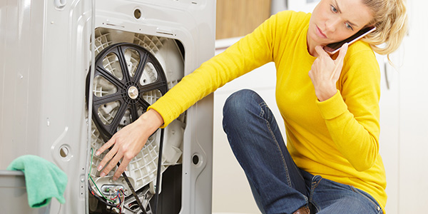 Woman Trying to Fix Washing Machine