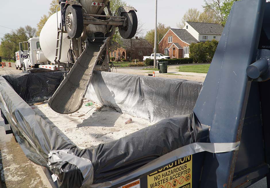 Cement Mixer Truck Above Concrete Dumpster