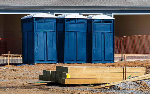 Three Porta Potties Sitting on a Construction Site