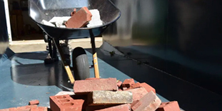 Wheelbarrow Filled With Bricks Inside Roll Off Dumpster