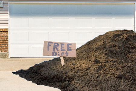 Free Dirt Sign on Pile of Dirt With Blueprint Background