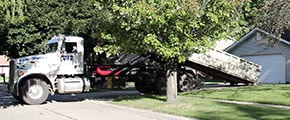 Delivery Truck Dropping Off a Roll Off Dumpster