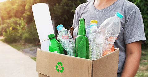 Man Carrying Box of Recyclables