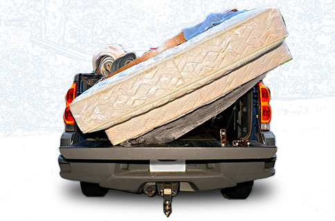 Pickup Truck Bed Filled With Mattress and Other Junk 