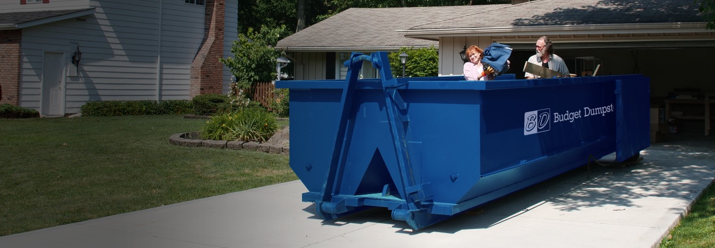Couple Filling a Roll Off Dumpster 
