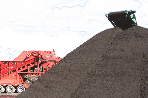 Large Pile of Asphalt Next to Dump Truck on Blueprint Background