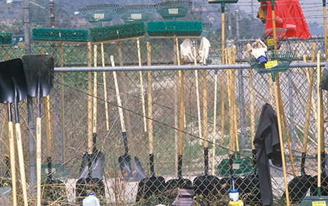 Tools, like shovels, gloves and trash bags, that are used for a waterway cleanup.