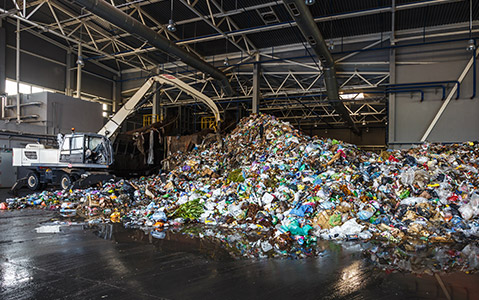 Inside of Waste Transfer Station With Large Pile of Garbage
