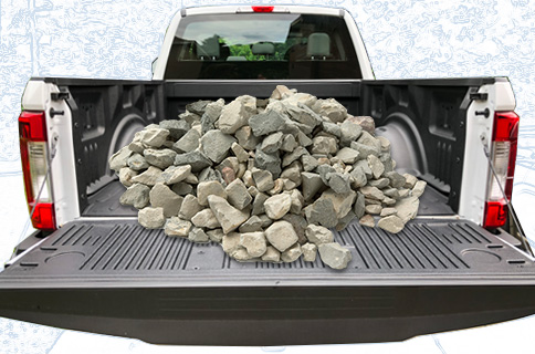 Pickup Truck Bed Filled With Rocks on Blueprint Background