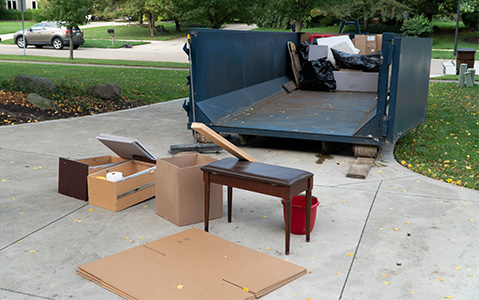 Blue Dumpster Filled Halfway